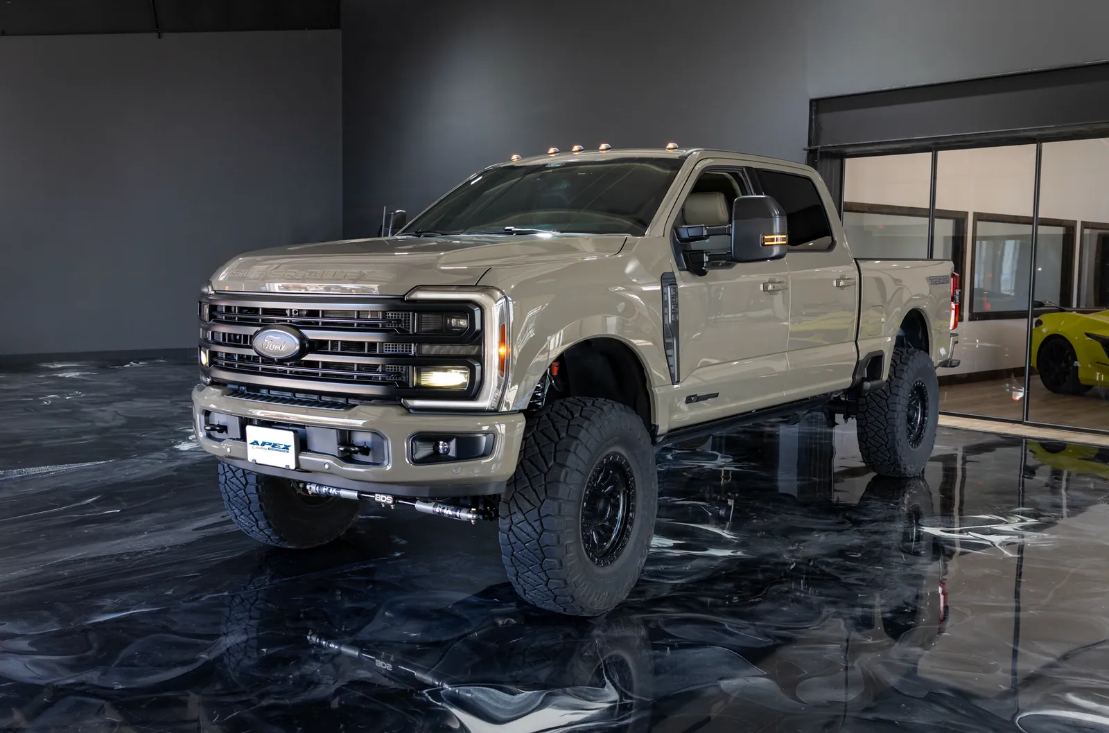 Lifted 2026 Ford F-350 Super Duty on BDS suspension inside the Apex Custom Innovations showroom