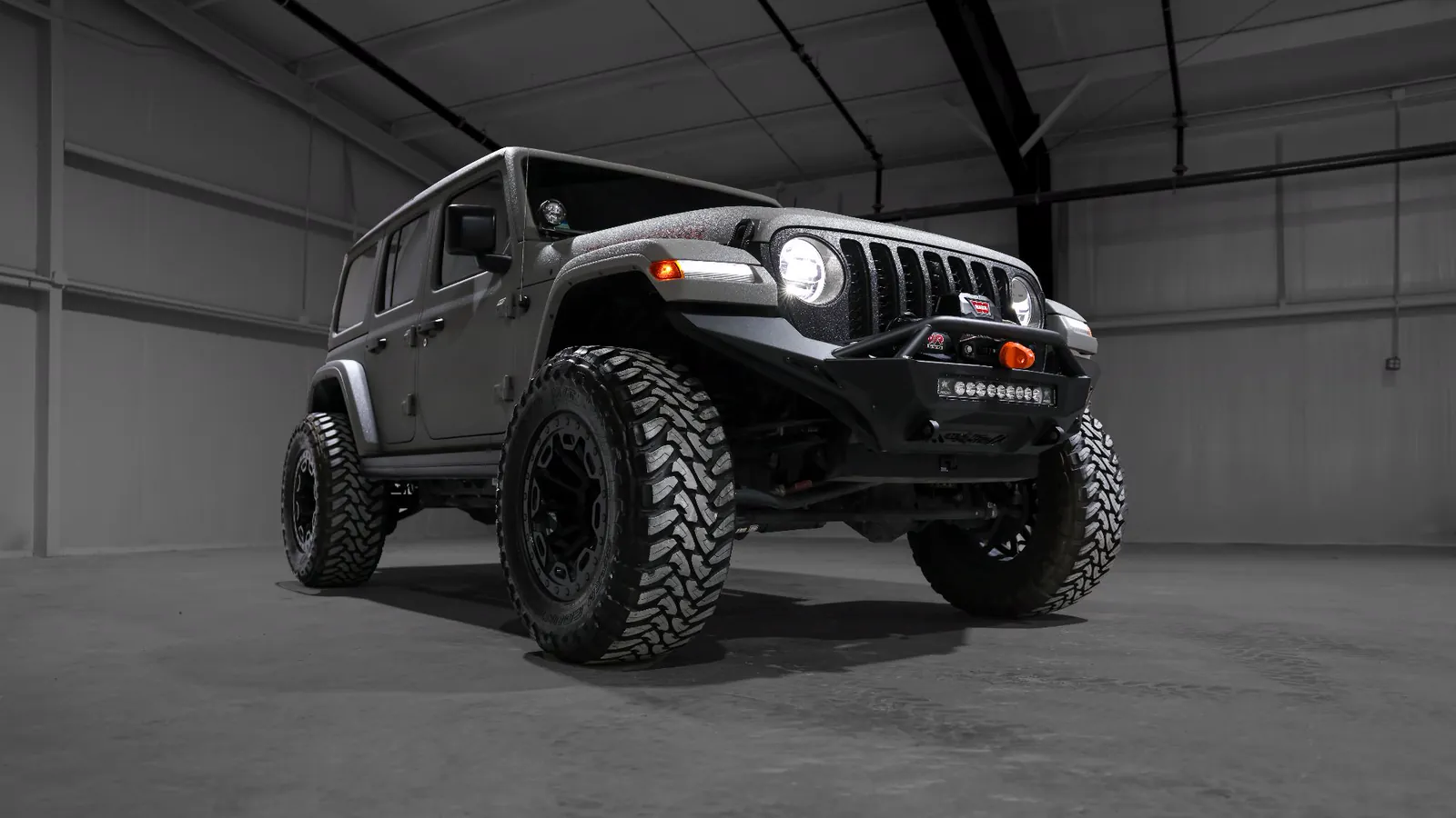 Lifted Jeep Wrangler Rubicon coated in Apex Armor with off-road bumper, winch and mud-terrain tires