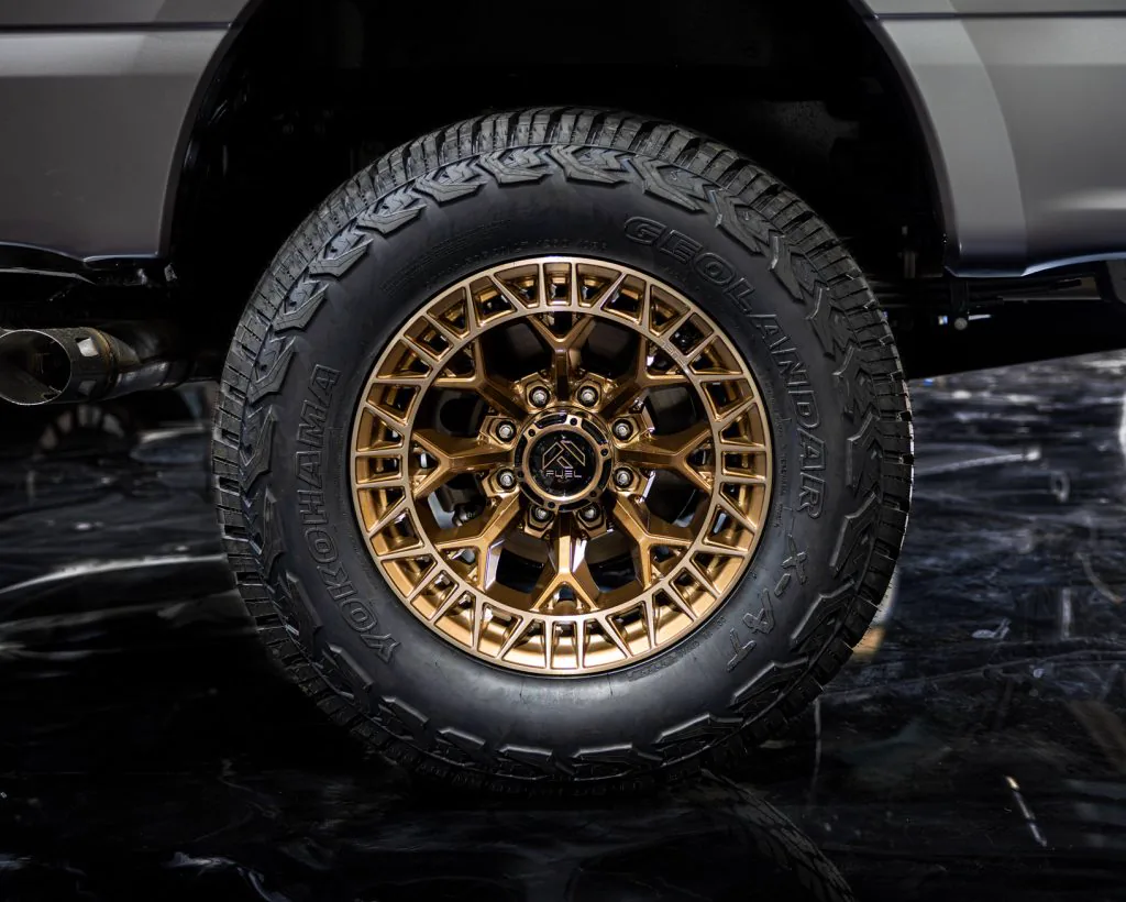 Bronze Fuel off-road wheel wrapped in a Yokohama Geolandar all-terrain tire